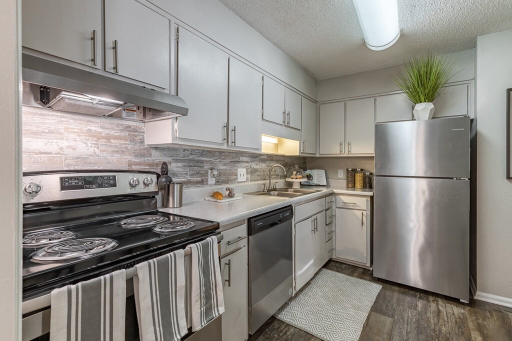 a kitchen with stainless steel appliances and white cabinets at Tucker Square, Stone Mountain, Georgia