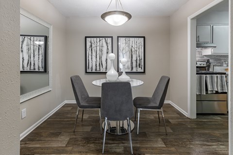 a dining room with a table and chairs.