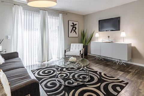 a living room with a couch and a glass coffee table