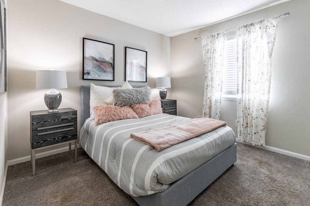 a bedroom with a bed and two nightstands and a window at Tucker Square, Stone Mountain 30083