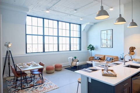 A kitchen and dining area with a table set for two.