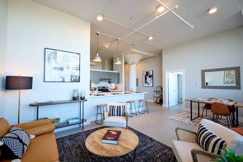 A living room with a white couch and a coffee table with a book on it.