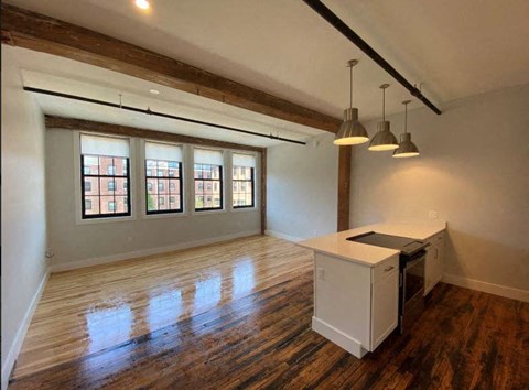 A kitchen area with a white counter and a stove is shown.