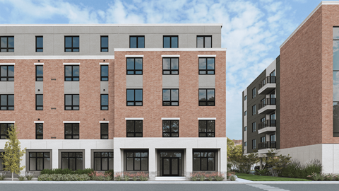 A modern building with a red brick facade and large windows.
