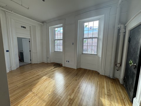A room with wooden floors and white walls.