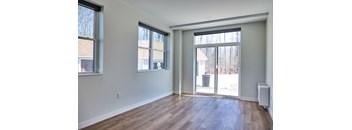 A room with a sliding glass door leading to a backyard.