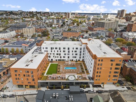 an aerial view of a building with a clock on the side of it