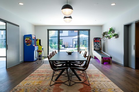 A dining room with a table and chairs.
