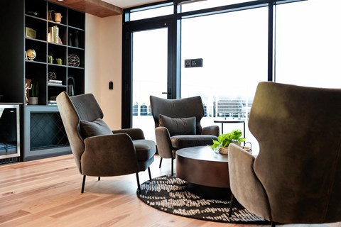A living room with a table and chairs.