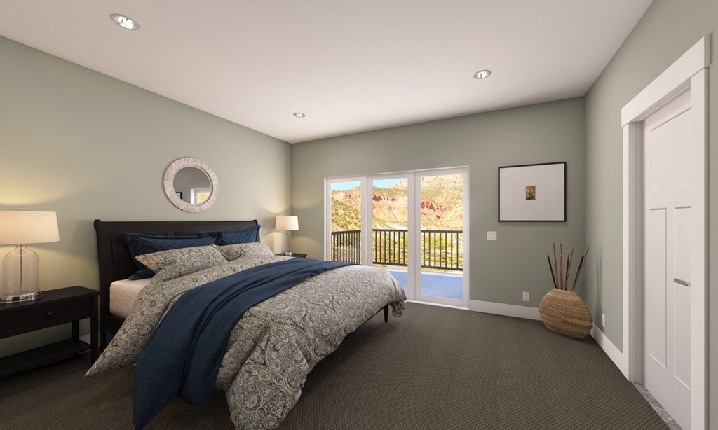 Master Bedroom With Glass Slide Door and Carpeted Flooring at Moenave Townhomes in Springdale, Utah