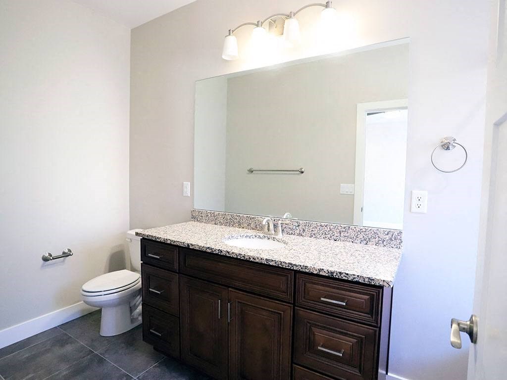 Bathroom With Large Mirror, Marble Counters, Light Fixture at Moenave Townhomes in Springdale, Utah
