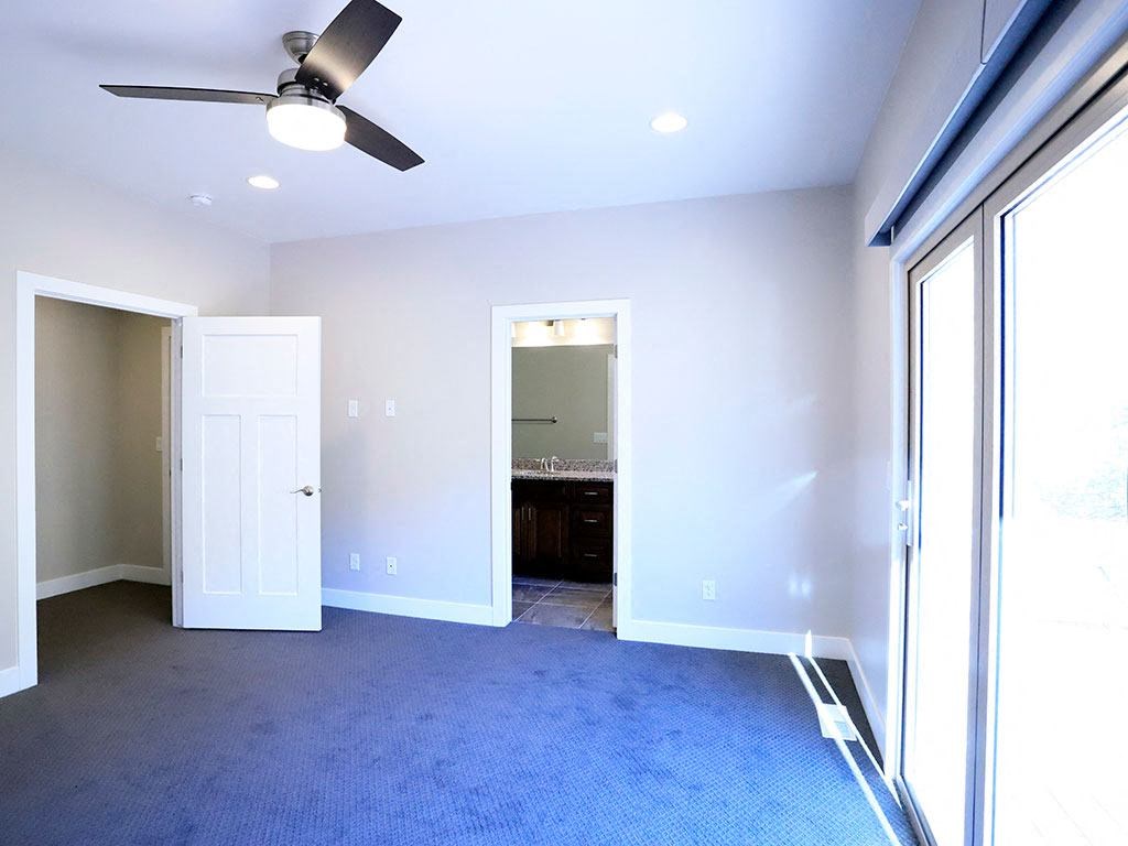 Sliding Door in Bedroom Space with Light Fixture, Bathroom at Moenave Townhomes in Springdale, Utah