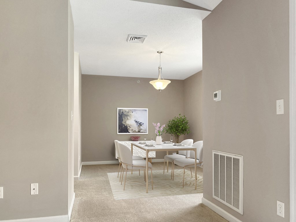 an empty dining room with a white table and chairs
