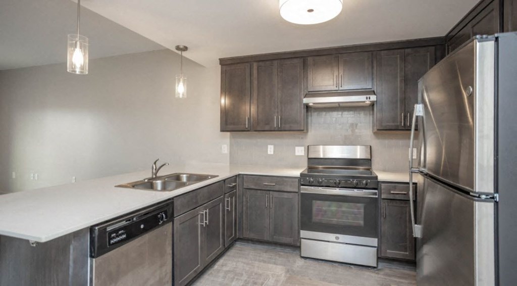 a kitchen with stainless steel appliances and wooden cabinets