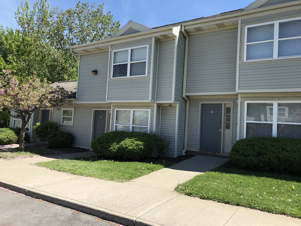 a with a sidewalk in front of it