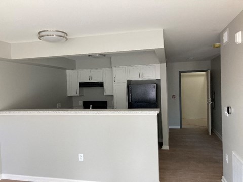 Interior a kitchen with white cabinets and a counter top