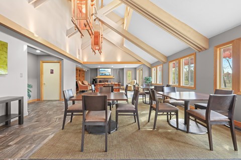 A dining room with a long table and chairs.