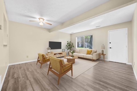 A living room with a white couch and a television.