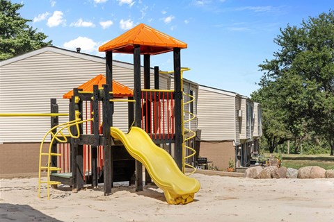 Playground with yellow slide and orange canopy at Indian Valley Apartments, Kent, 44240