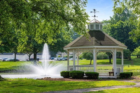 Gazebo beside pond with decorative fountain at Hunters Lake Apartments, Cuyahoga Falls, OH 44221