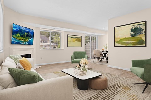 A living room with a green couch and a painting on the wall.