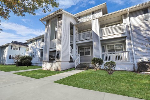 White two story apartment building exterior at Plantation Oaks Apartments, Georgia