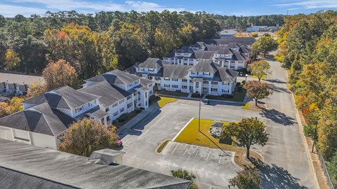 Aerial view of apartment community with parking at Plantation Oaks Apartments, Savannah, GA 31419