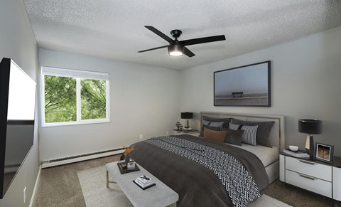 Bedroom with gray bedding and ceiling fan at The Dexter Apartments, Denver, 80246