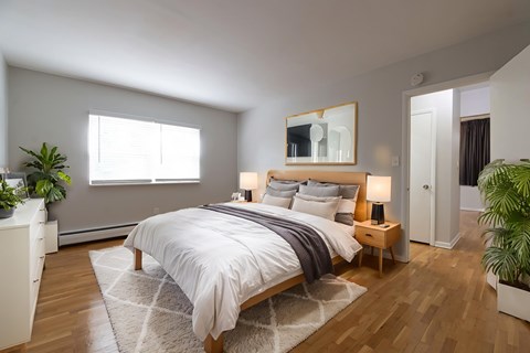 A bedroom with a large bed and a mirror above it.