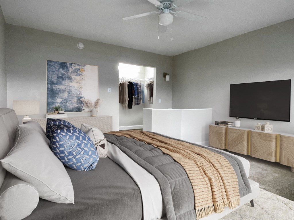 a bedroom with a bed and a ceiling fan