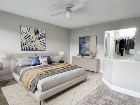a bedroom with a bed and a ceiling fan