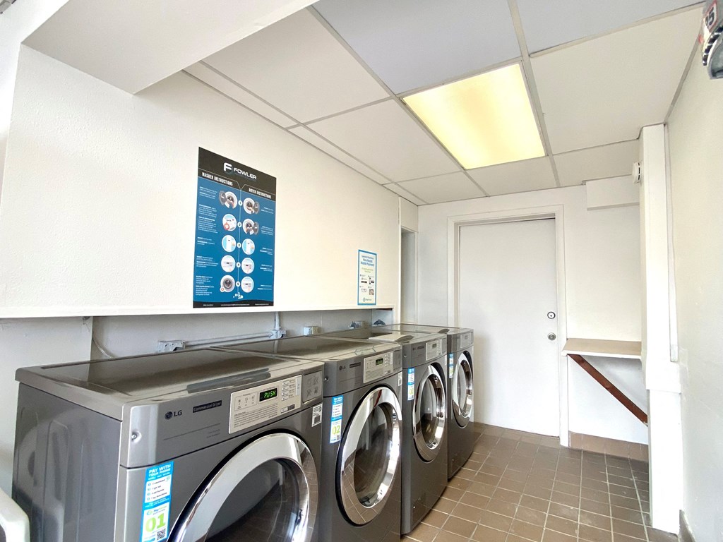 a washer and dryer in a laundry room with a display of washing machines