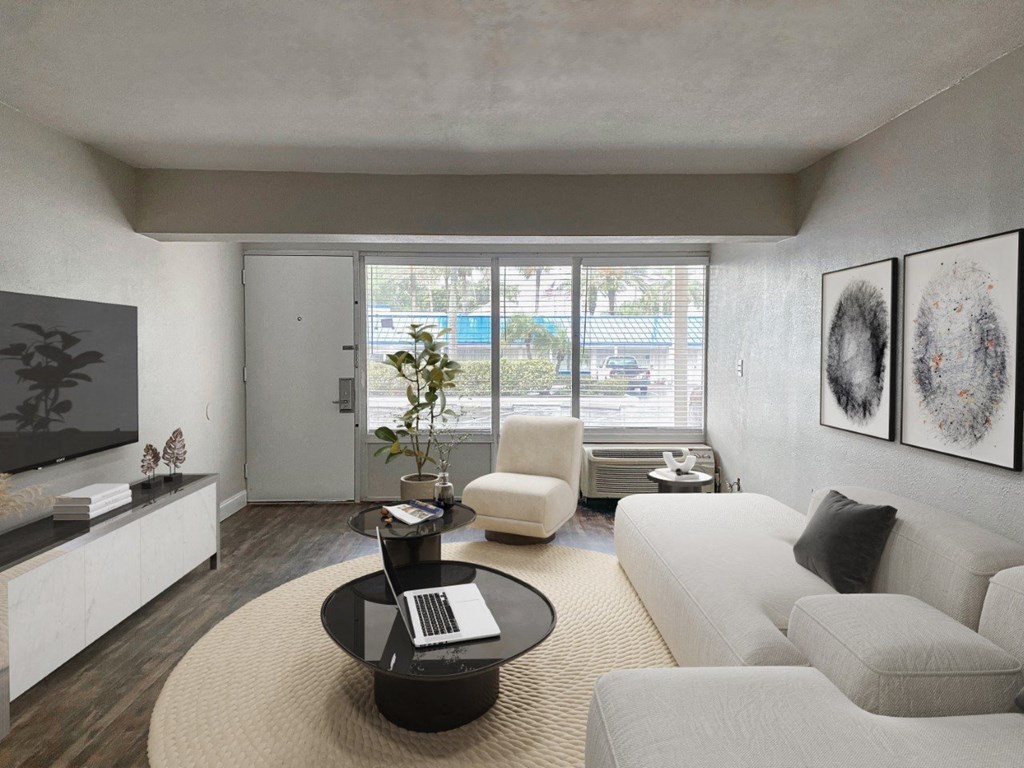 a living room with white furniture and a large window