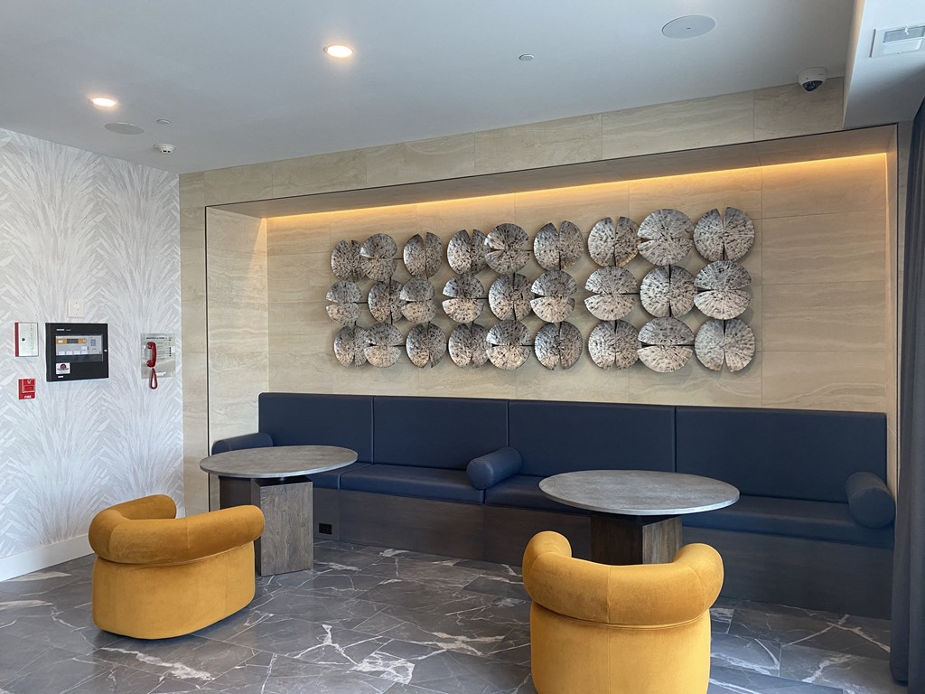 a wall of metal plates in the lobby of a hotel