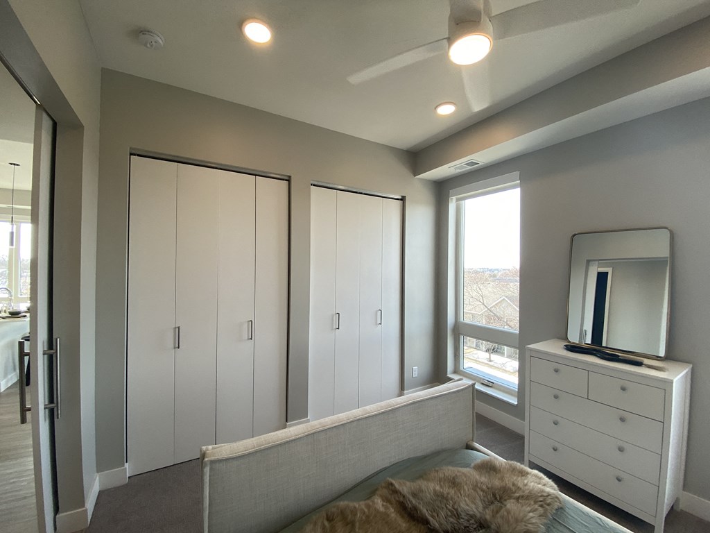 a bedroom with a bed and a dresser