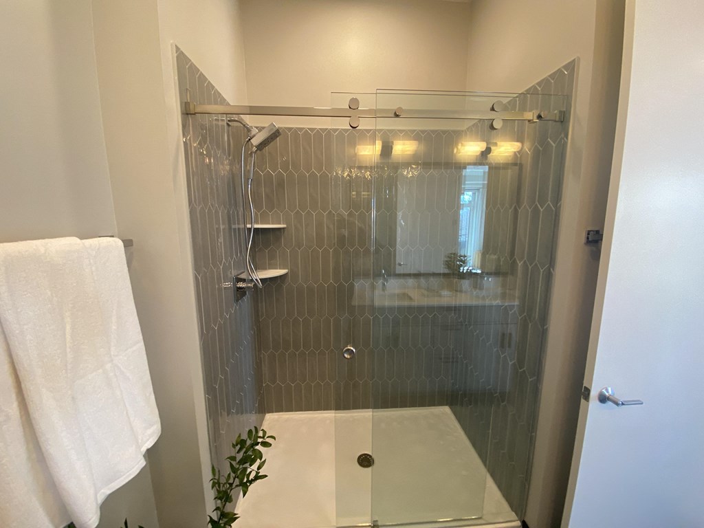 a small bathroom with a glass shower door
