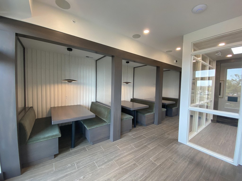 a room with a table and chairs and a door