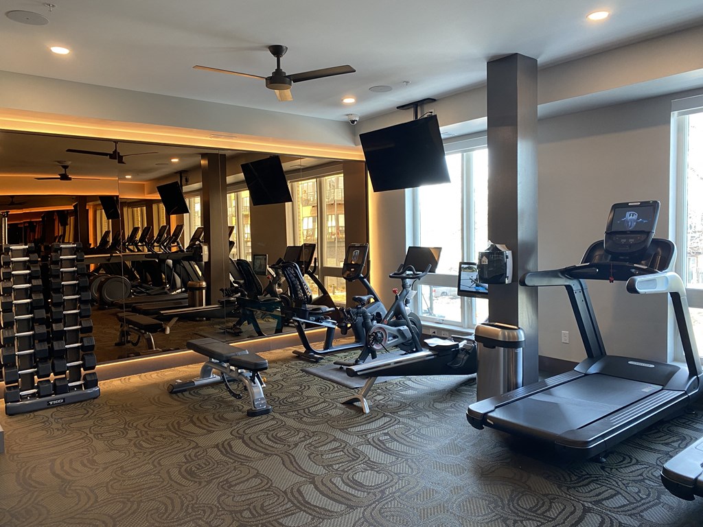 a gym with treadmills and other exercise equipment