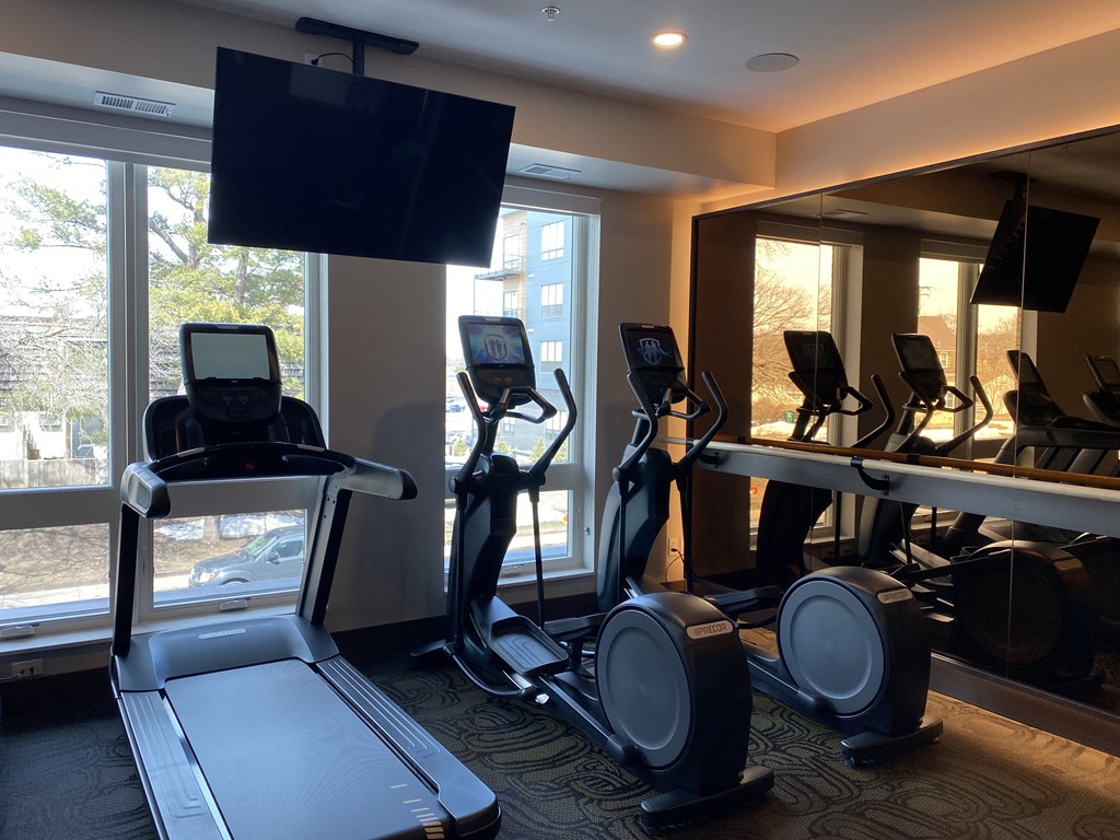 a gym with treadmills and exercise bikes