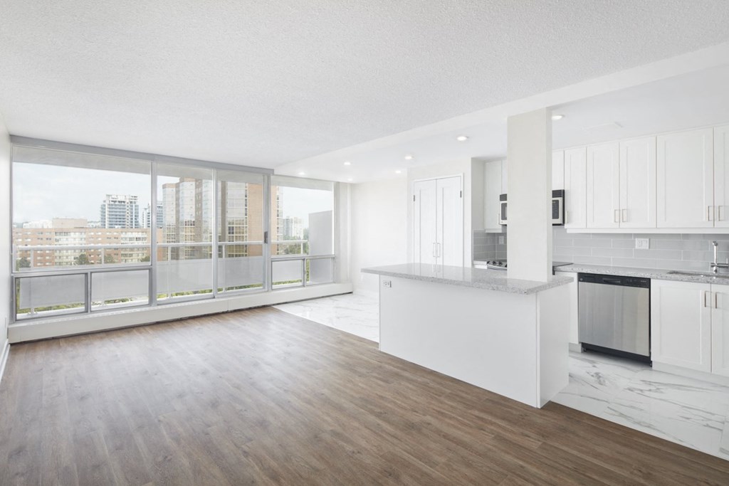 an open living room and kitchen with a view of the city