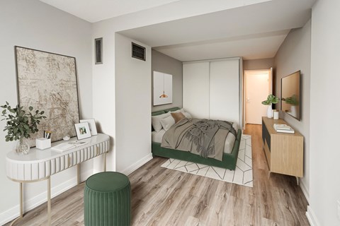 a bedroom with a bed and a desk in a small room