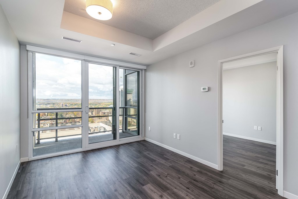 an empty living room with sliding glass doors and a balcony