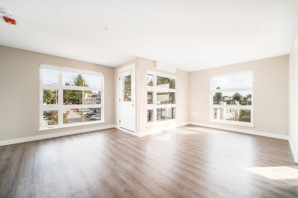 Beautifully staged two-bedroom apartment, looking from the living room straight through to the kitchen.