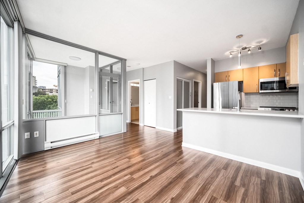 View of a suite, looking back at the kitchen. Floor-to-ceiling windows ensure a ton of natural light.