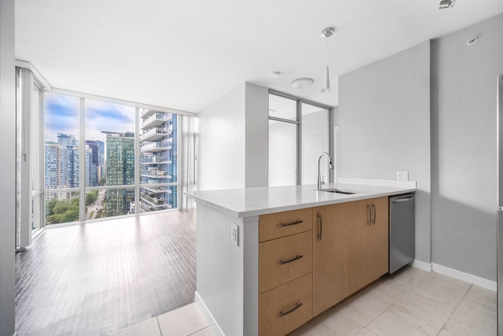 View from the kitchen of a suite, looking across the living room out to the floor-to-ceiling window views.