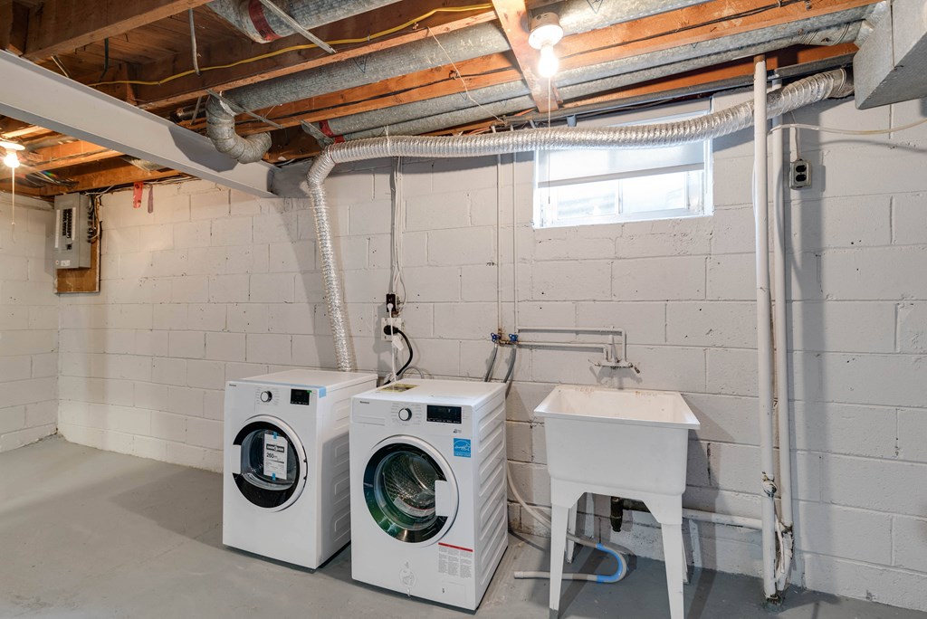 Washer and dryer with wash basin in basement