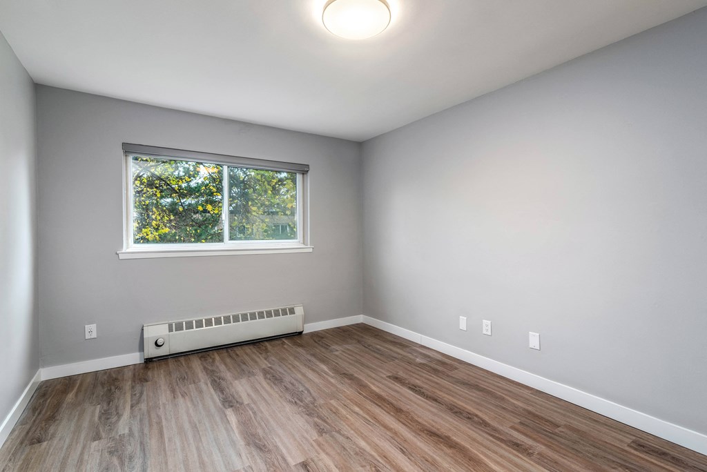 Bedroom with window overlooking trees