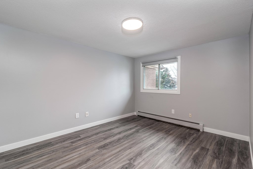 Bedroom with window overlooking trees