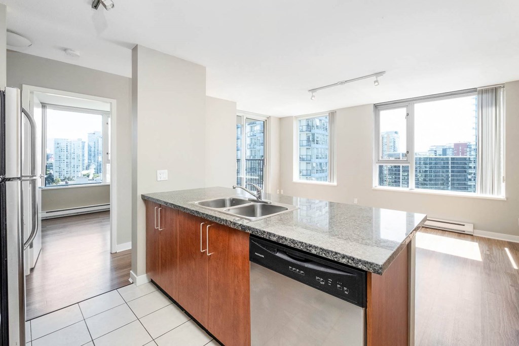 a kitchen with a sink and a large window