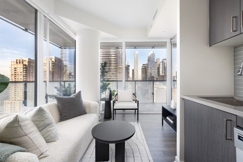 A modern living room with a view of the city skyline.